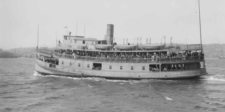 vintage photo of a boat with migrants near ellis island