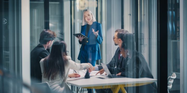 A woman leading an office meeting.