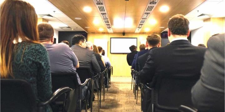 seated crowd in large conference room