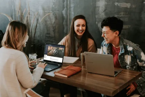 Laughing people with laptops